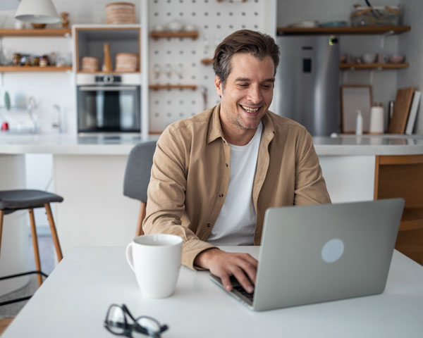 Male on laptop smiling