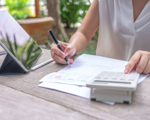 Woman calculating manually costs without pricing calculator